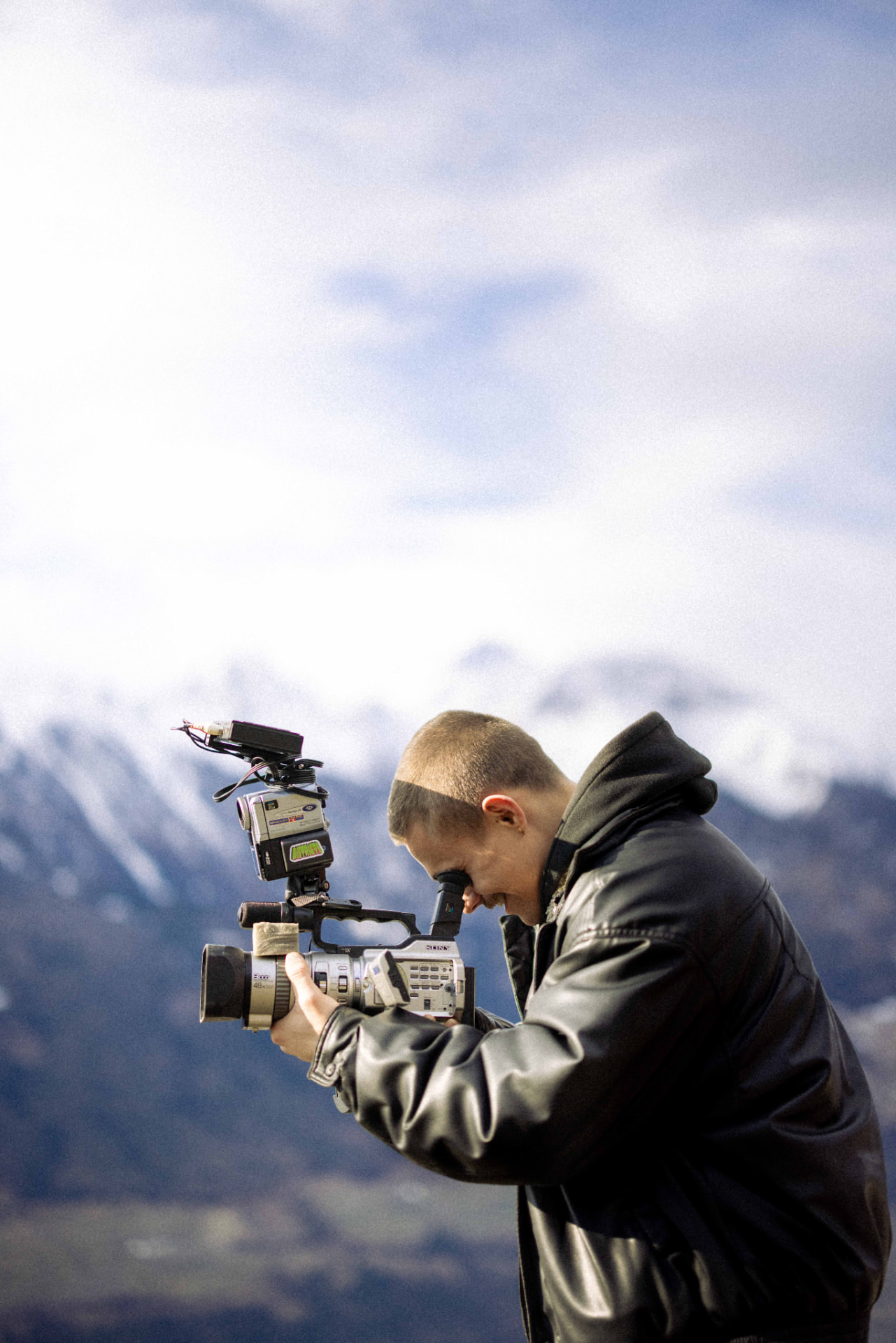 David Ruso filming with a professional camera in the mountains